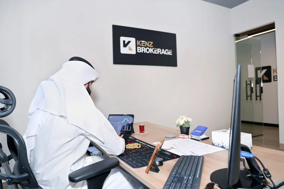 Kenz Brokerage office employee at desk